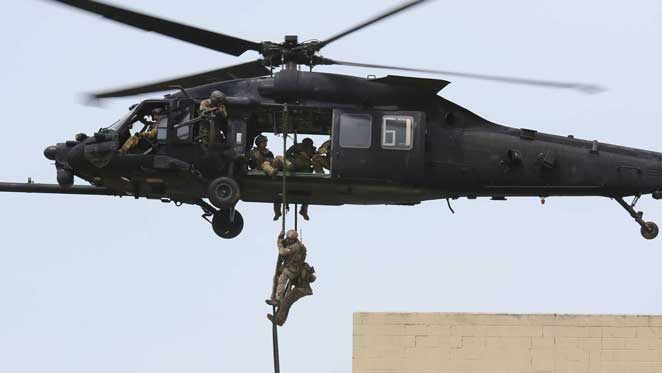 5th special forces group airborne soldier rappelling out of a helicopter
